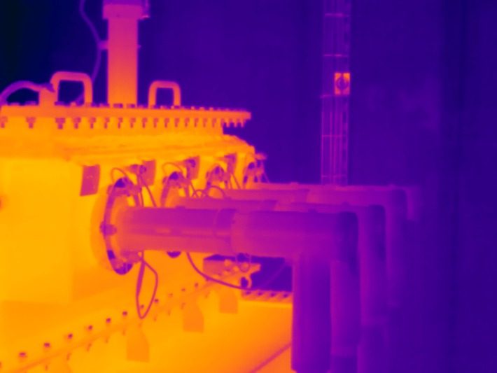 Thermografieaufnahme einer Industrieanlage mit erwärmtem Gehäuse und angeschlossenen Rohrleitungen
